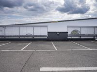 the large truck is parked in a parking lot with its door open and the sky above