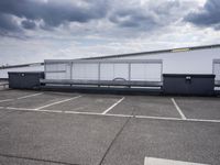 the large truck is parked in a parking lot with its door open and the sky above