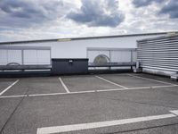 the large truck is parked in a parking lot with its door open and the sky above