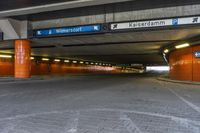 a street sign in the middle of a tunnel entrance, indicating how far the tunnel is