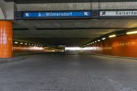 a street sign in the middle of a tunnel entrance, indicating how far the tunnel is