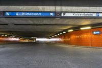 a street sign in the middle of a tunnel entrance, indicating how far the tunnel is