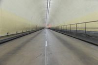 a photo taken inside of a tunnel with a car coming out of the tunnel that is lined up