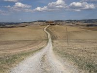 Exploring the Tuscan Countryside: A Dirt Road Amidst Rugged Landscape