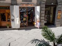 a shop in the village of menorca with a door on the outside is open