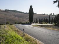 Tuscany Italy: Asphalt Road and Mountain Landscape