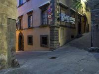 a narrow city street has been empty of people who are riding the bike on this road