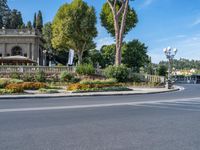 a beautiful place to live with people sitting and walking next to the road at the curb