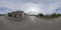 the camera panning shot is 360 - up on a curved road on a cloudy day