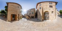 the 360 lens is showing several streets and buildings in this old town area with a sun