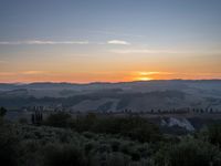 the sun shines brightly in this beautiful, tuscan - like landscape, but the light reflects it's orange color