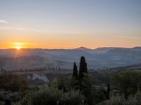 the sun shines brightly in this beautiful, tuscan - like landscape, but the light reflects it's orange color