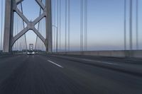 the car is driving on the bridge at twilighttime in motion around the edge of the bridge