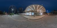 a 360 - ray picture of a city building and surrounding area in twilight time with city street lights