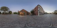 a view of the town square at twilight from an 360 - angle perspective mirror of a brick building