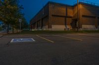 parking lot lit up with the light from an open window at twilight as seen from outside