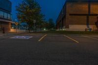 parking lot lit up with the light from an open window at twilight as seen from outside