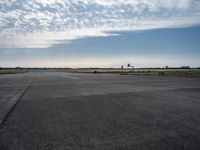 a jetliner sitting on top of an airport tarmac next to another jetliner