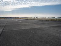 a jetliner sitting on top of an airport tarmac next to another jetliner