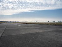 a jetliner sitting on top of an airport tarmac next to another jetliner