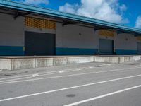 an empty lot with an empty parking lot in the background and clouds in the distance