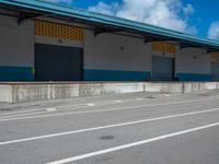 an empty lot with an empty parking lot in the background and clouds in the distance