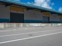 an empty lot with an empty parking lot in the background and clouds in the distance