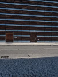 two men are standing outside next to the building on which is a parking meter and car park