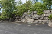 two parking spaces with yellow line markings next to rock wall in a residential neighborhood area