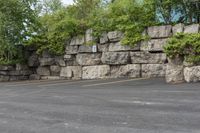 two parking spaces with yellow line markings next to rock wall in a residential neighborhood area