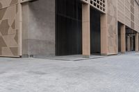 a couple of people sitting on benches next to a building on a city street during the day