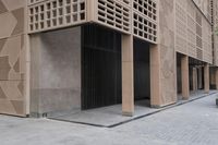 a couple of people sitting on benches next to a building on a city street during the day