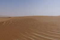 there is a small boat in the sand of this desert area with no trees or bushes