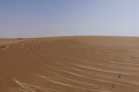 there is a small boat in the sand of this desert area with no trees or bushes