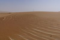 there is a small boat in the sand of this desert area with no trees or bushes