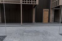 a fire hydrant on the sidewalk of a building next to a tree with wood beams