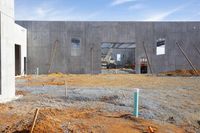 an exterior view of a large construction site that's very under construction with concrete walls