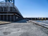 this is the image of an under construction walkway and walkway next to the water in the background