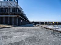 this is the image of an under construction walkway and walkway next to the water in the background