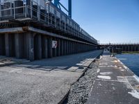 this is the image of an under construction walkway and walkway next to the water in the background