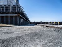 this is the image of an under construction walkway and walkway next to the water in the background