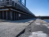 this is the image of an under construction walkway and walkway next to the water in the background