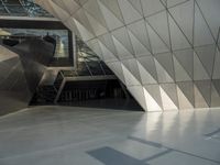 an underground area with a staircase in the middle of it with metal design on the walls