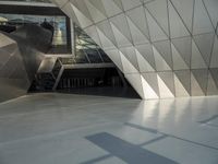 an underground area with a staircase in the middle of it with metal design on the walls