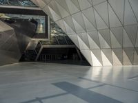 an underground area with a staircase in the middle of it with metal design on the walls