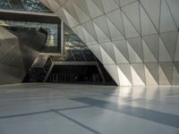 an underground area with a staircase in the middle of it with metal design on the walls