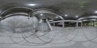 there are some stairs and steps at this underground station by some building as seen in this fish eye photo