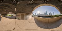 a large fish eye lens of the chicago skyline and skyline as seen from underneath an overpass