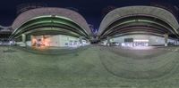 three fisheyes of different sizes in a building at night, facing each other