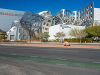 the building is designed like an unusual cube with some metal and stone construction on it